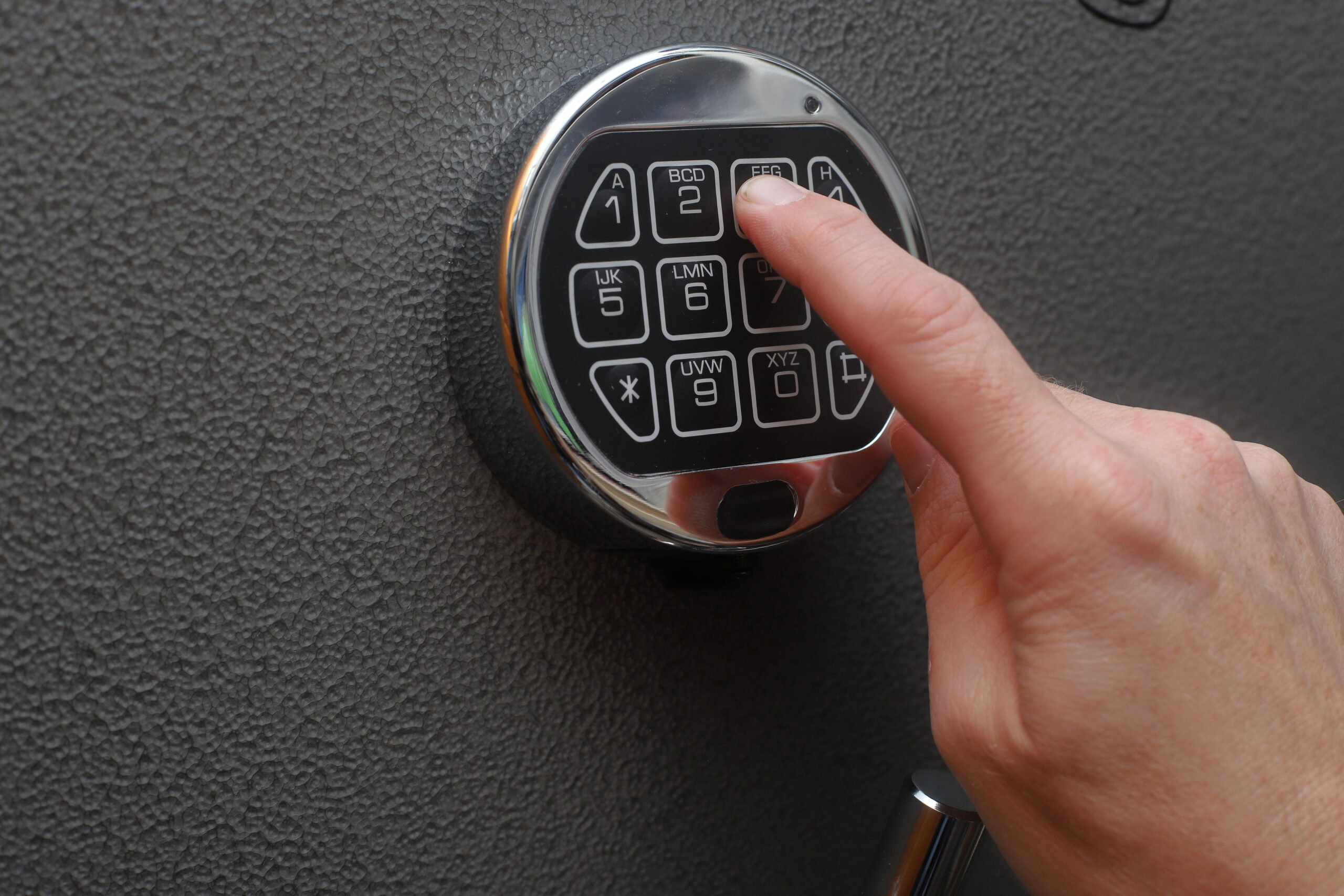 Hand opening a safe.